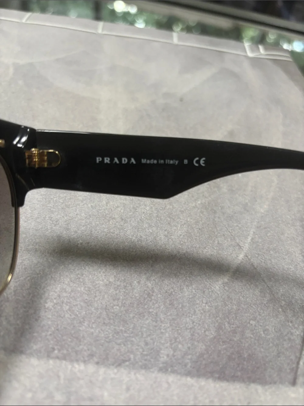 Prada Black Cat-Eye Sunglasses with Gold Trim